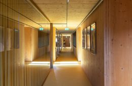 a long hallway with wooden walls and a yellow floor