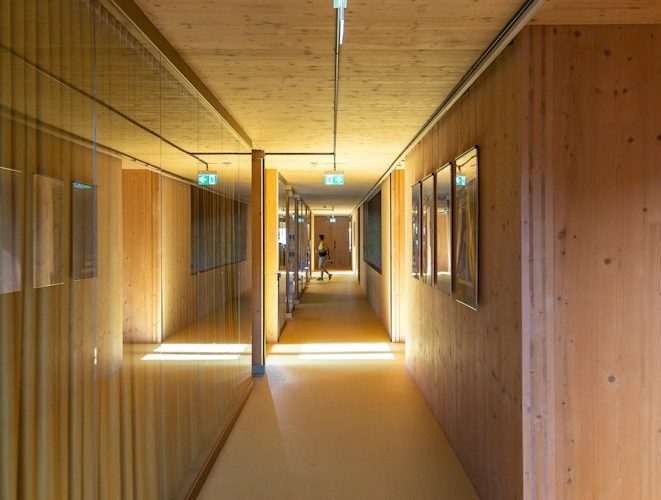 a long hallway with wooden walls and a yellow floor