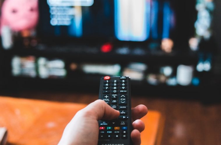 person holding black remote control