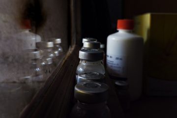 A bottle of liquid sitting on top of a counter