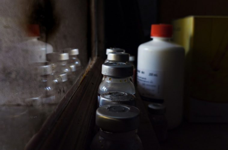A bottle of liquid sitting on top of a counter